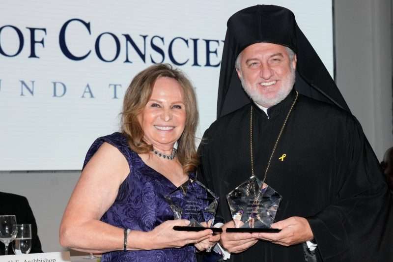 His Eminence Archbishop Elpidophoros of America and Humanitarian Marta Batmasian holding their Appeal of Conscience Awards at the 59th Annual Gala